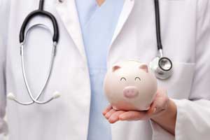 Doctor Holding Piggy Bank — in Ocean City, MD Doctor Holding Piggy Bank — in Ocean City, MD
