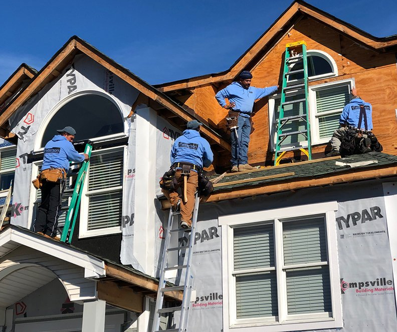 Patterson Homes and Construction Crew installing siding