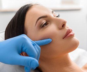 Plastic Surgery — Surgeon Examining A Patient's Face in Orlando, FL Plastic Surgery — Surgeon Examining A Patient's Face in Orlando, FL