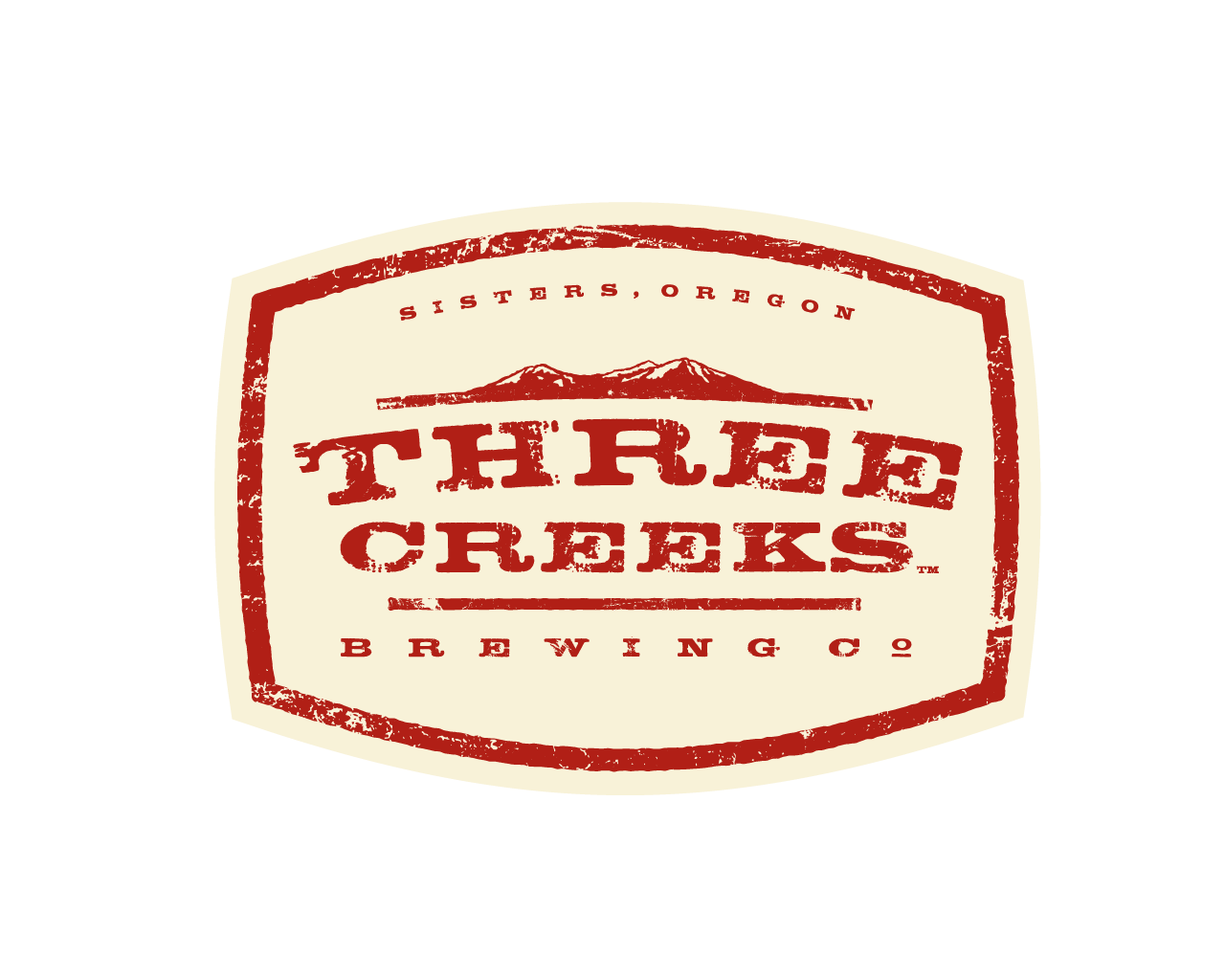 A logo for three creek brewing co. with a mountain in the background