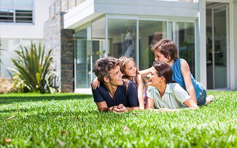 Bermuda Sod — Family Laying on Grass in Hastings, FL Bermuda Sod — Family Laying on Grass in Hastings, FL