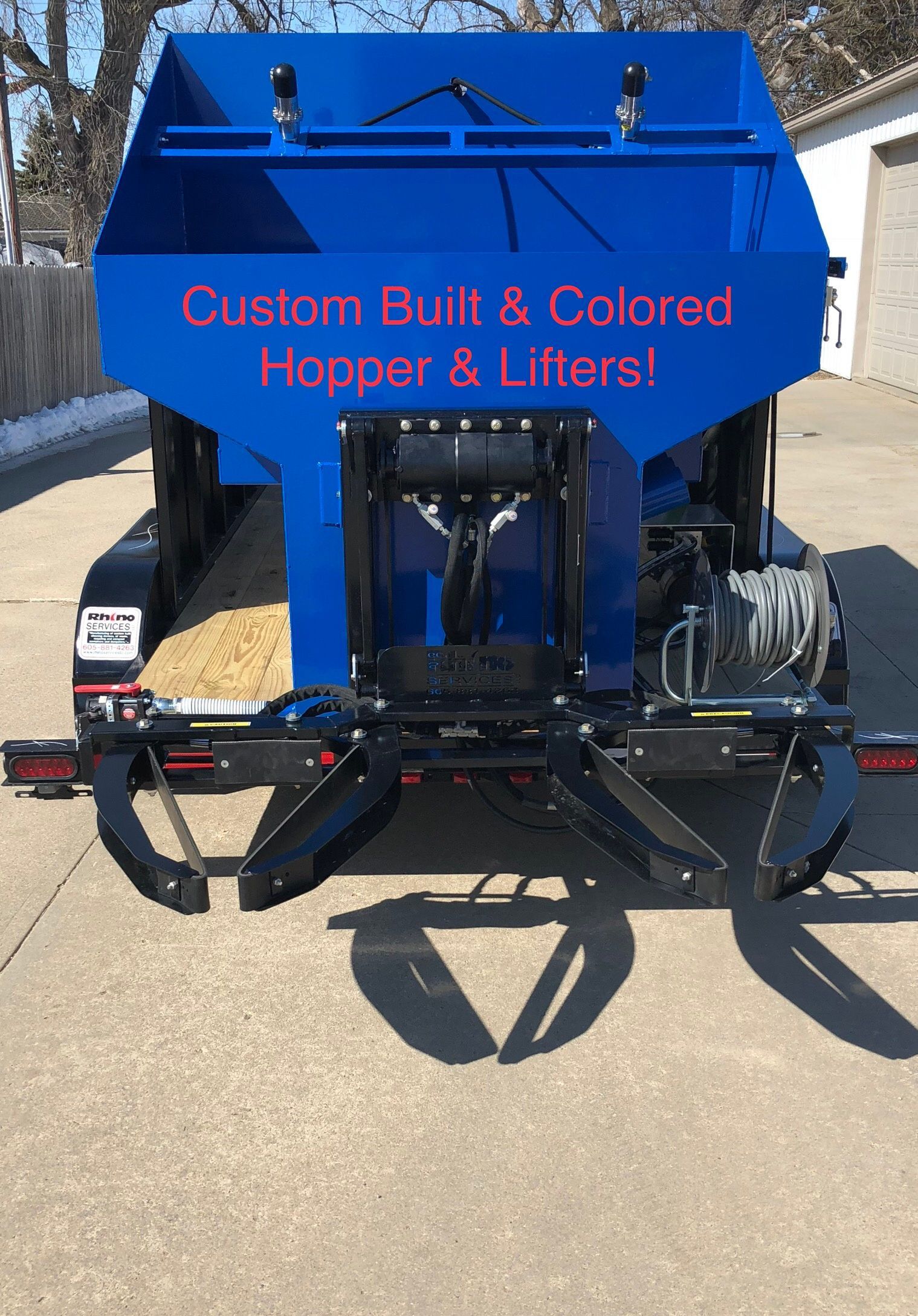 garbage can cleaning equipment with blue hopper and two black lifters