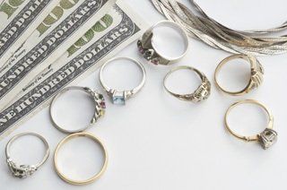 gold and silver rings being traded for hundred dollar bills