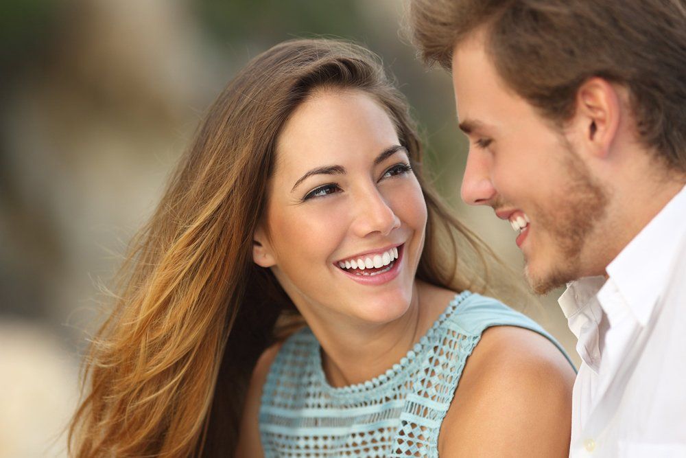 Smiling Couple with Perfect Smile — Ballina Denture Clinic Michael J Parker in Ballina, NSW