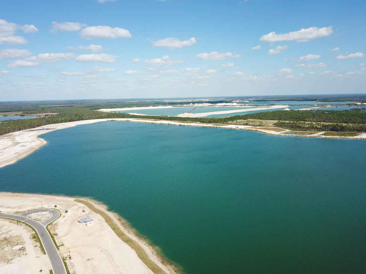 An aerial view of a large body of water surrounded by trees.