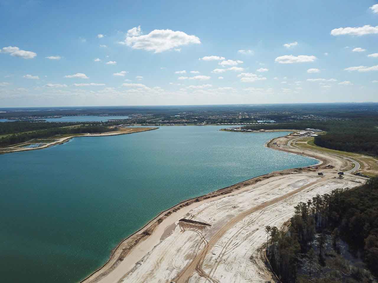 An aerial view of a large body of water surrounded by trees.