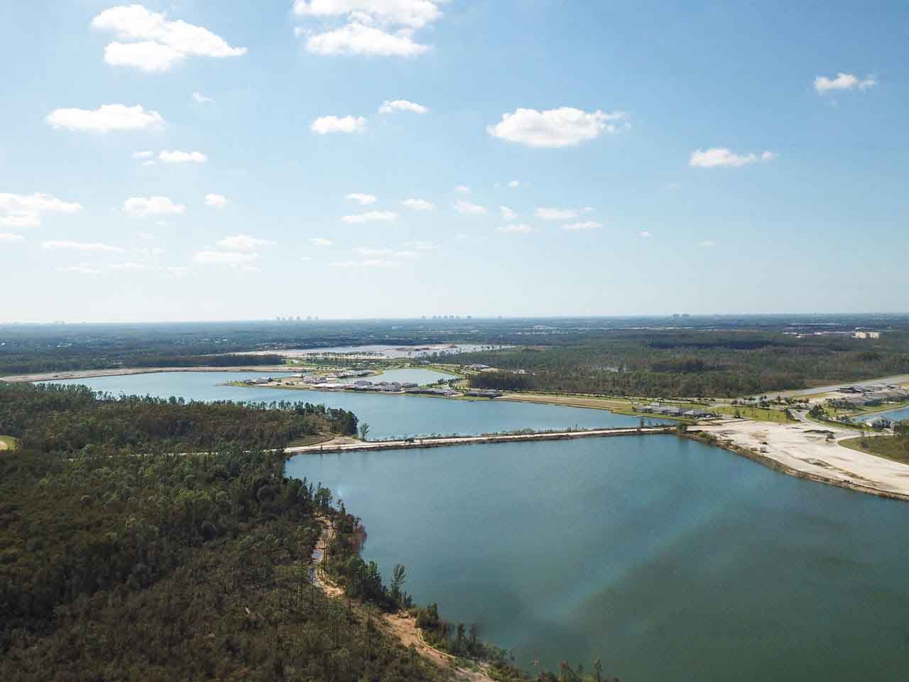 An aerial view of a large body of water surrounded by trees.