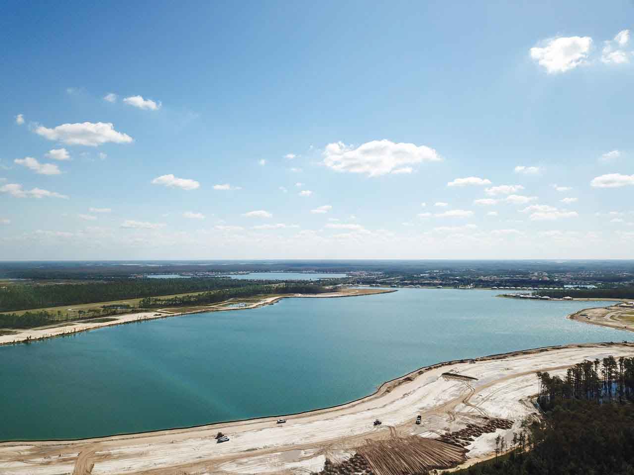 An aerial view of a large body of water surrounded by trees.
