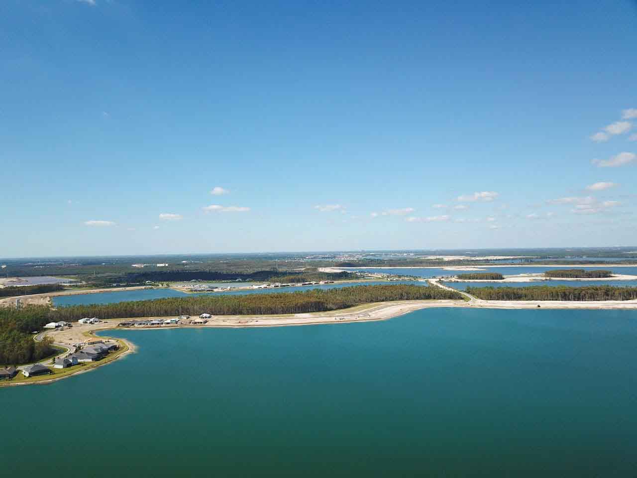 An aerial view of a large body of water with a small island in the middle.