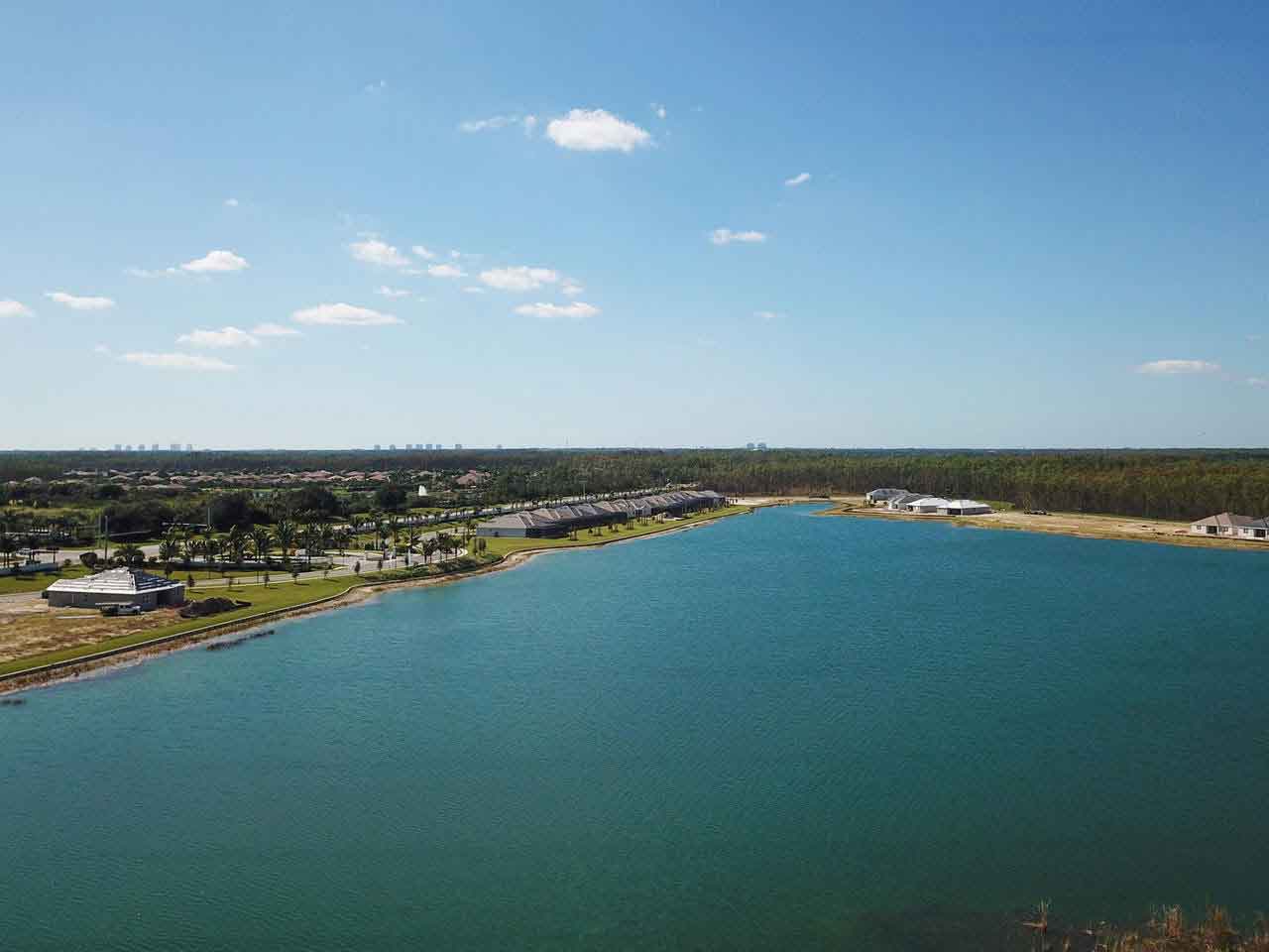 An aerial view of a large body of water surrounded by trees.