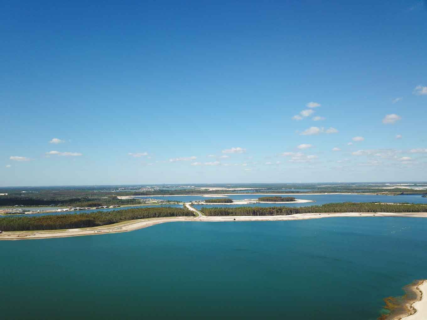 An aerial view of a large body of water surrounded by trees.