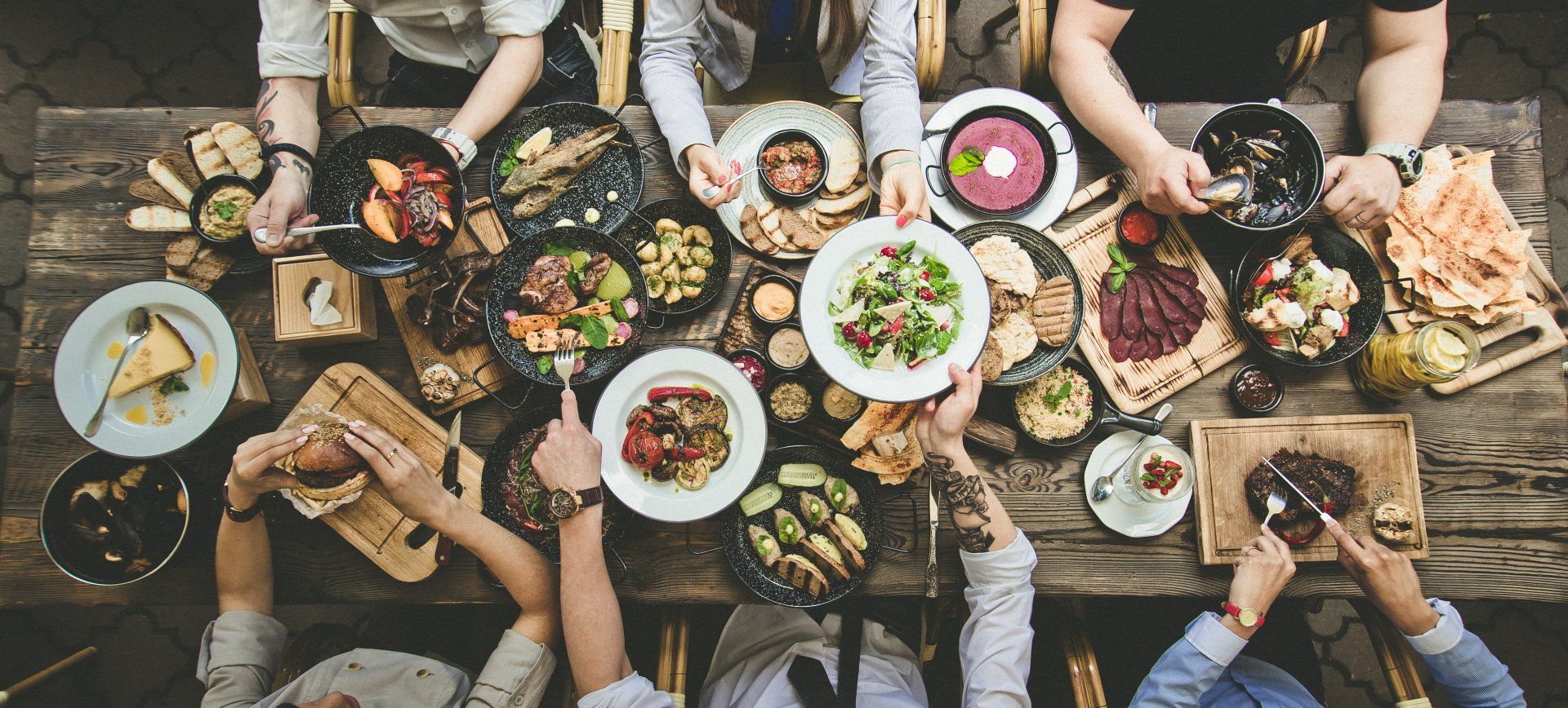 A group of people are sitting at a table eating food.