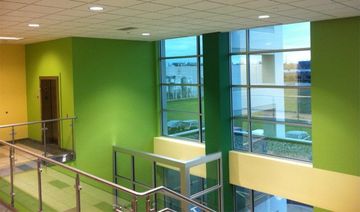 Green and yellow painted apartment hallway.