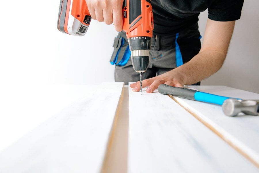 Man Using Cordless Electric Drill — Toledo, OH — West Equipment Co. Inc. Man Using Cordless Electric Drill — Toledo, OH — West Equipment Co. Inc.