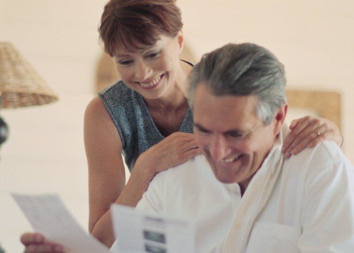Couple at Home Looking at Paperwork — Insurance in Port Orange, FL Couple at Home Looking at Paperwork — Insurance in Port Orange, FL