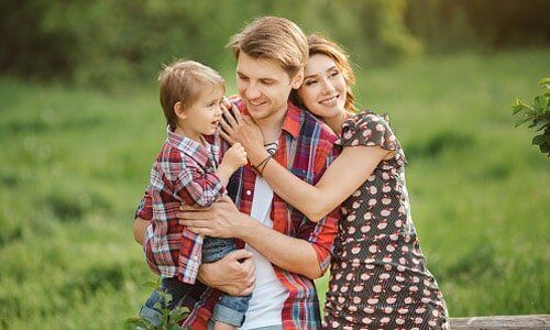 Happy Family in a Park — Insurance in Port Orange, FL Happy Family in a Park — Insurance in Port Orange, FL