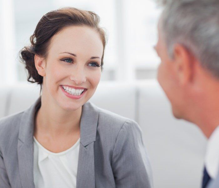Cheerful Businesswoman Talking to Her Workmate — Insurance in Port Orange, FL Cheerful Businesswoman Talking to Her Workmate — Insurance in Port Orange, FL