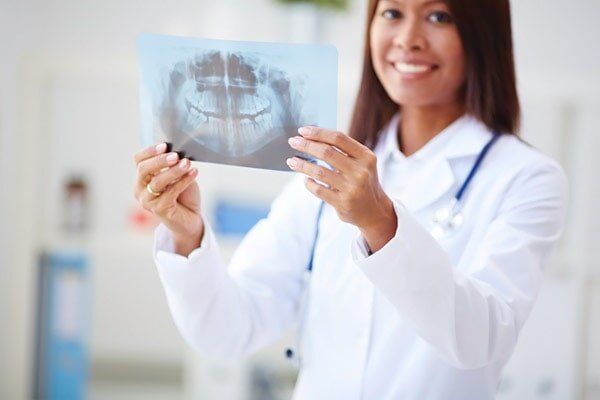 Dentist Holding Xray — Insurance in Port Orange, FL Dentist Holding Xray — Insurance in Port Orange, FL