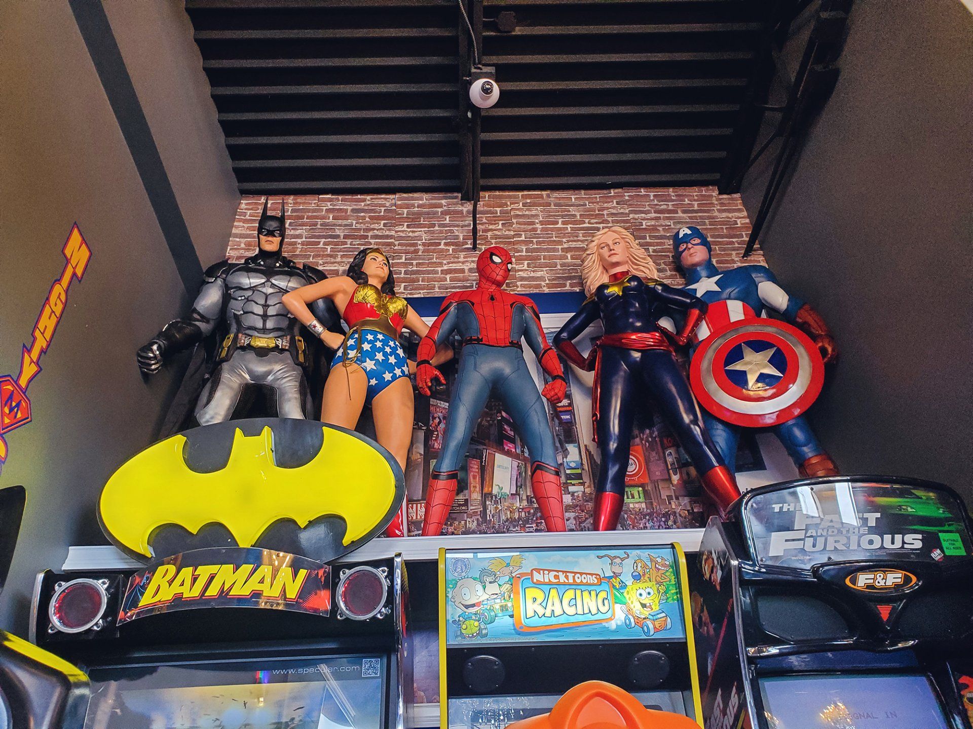 Mighty Smiles Dental, Dallas & Fort Worth. A bunch of action figures are sitting on top of a batman sign