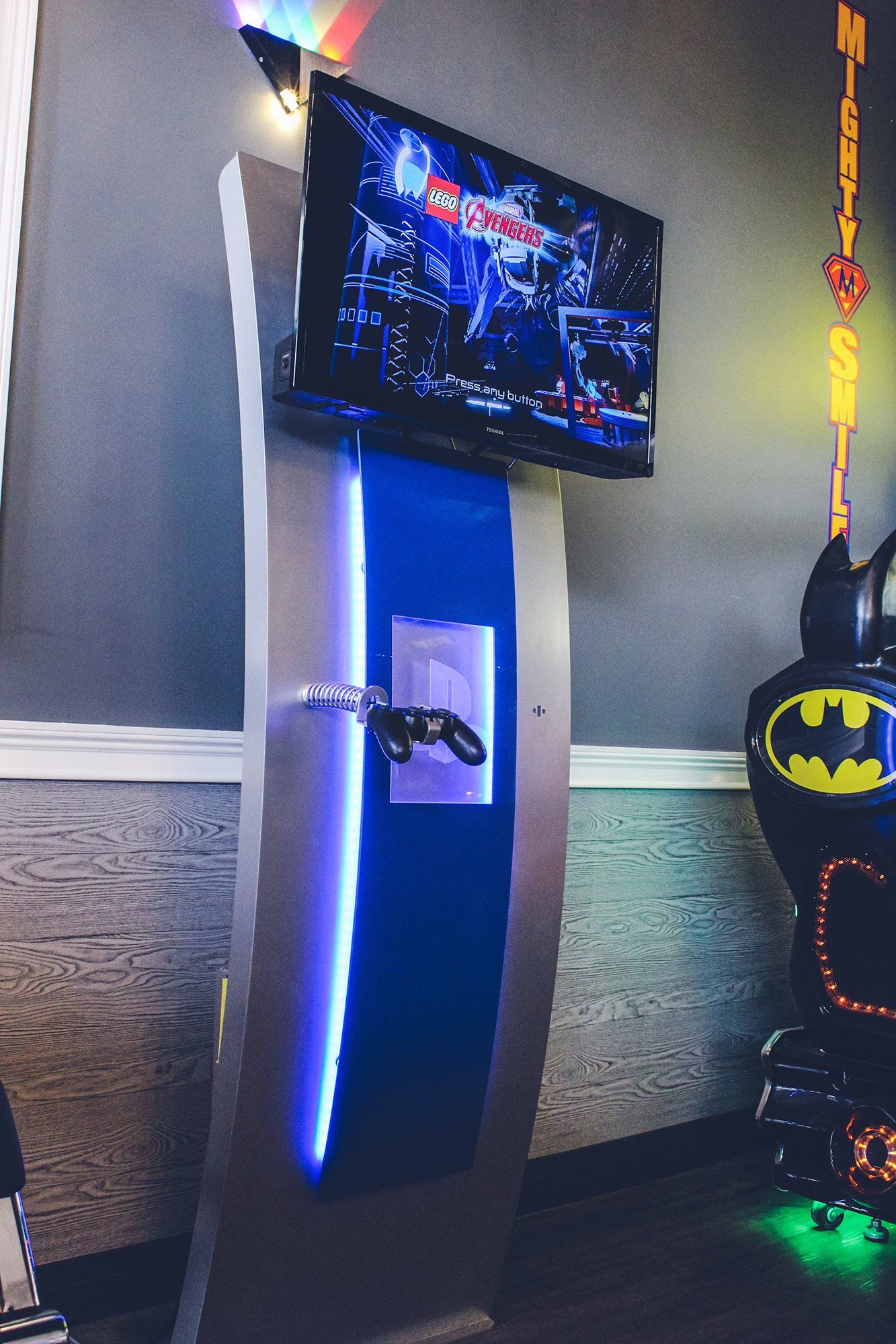 Mighty Smiles Dental, Dallas & Fort Worth. A batman is hanging on a wall next to a television.