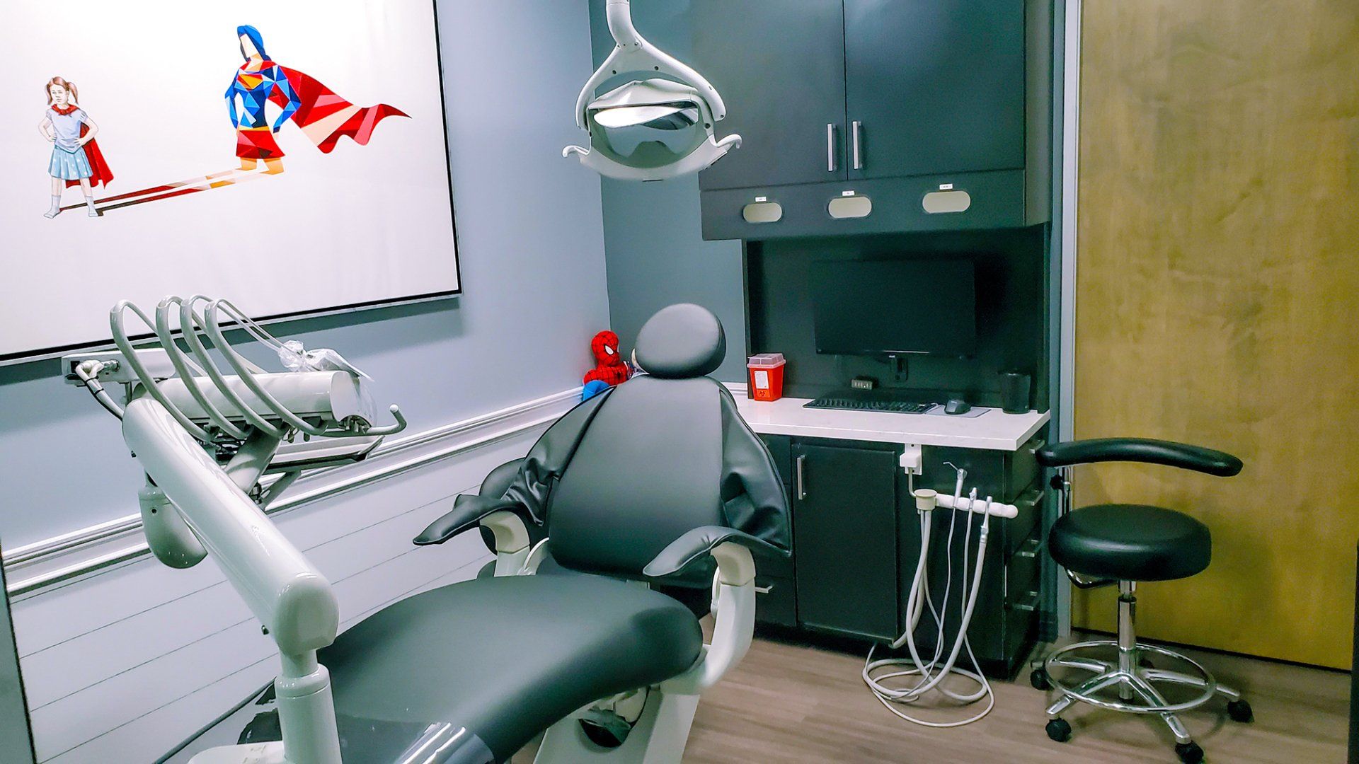 Mighty Smiles Dental, Dallas & Fort Worth. A dental office with a dental chair and a television on the wall.