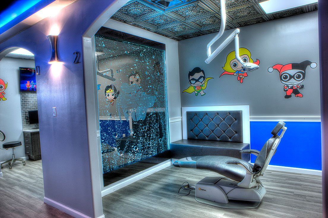 A dental office with a dental chair and a bench.