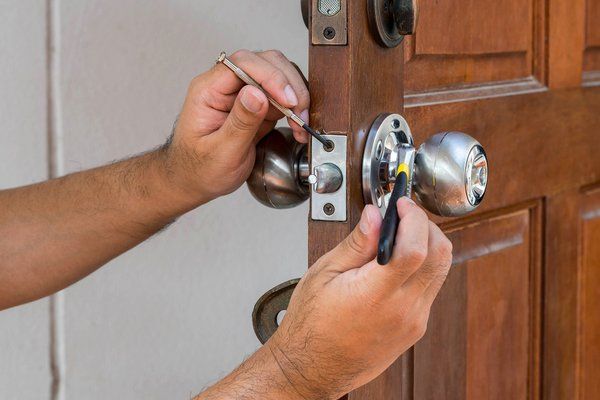 Installation and Repair — Man Installing the Door Lock in Beaver, PA Installation and Repair — Man Installing the Door Lock in Beaver, PA