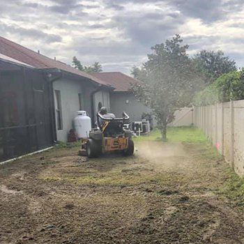 Mowing Backyard With Tractor — Lakewood Ranch FL — Emerald Green of Bradenton