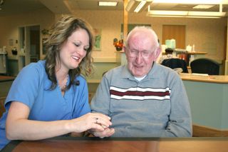 medication teaching & monitoring — Nurse Giving Pills to Patient in Baltimore, MD