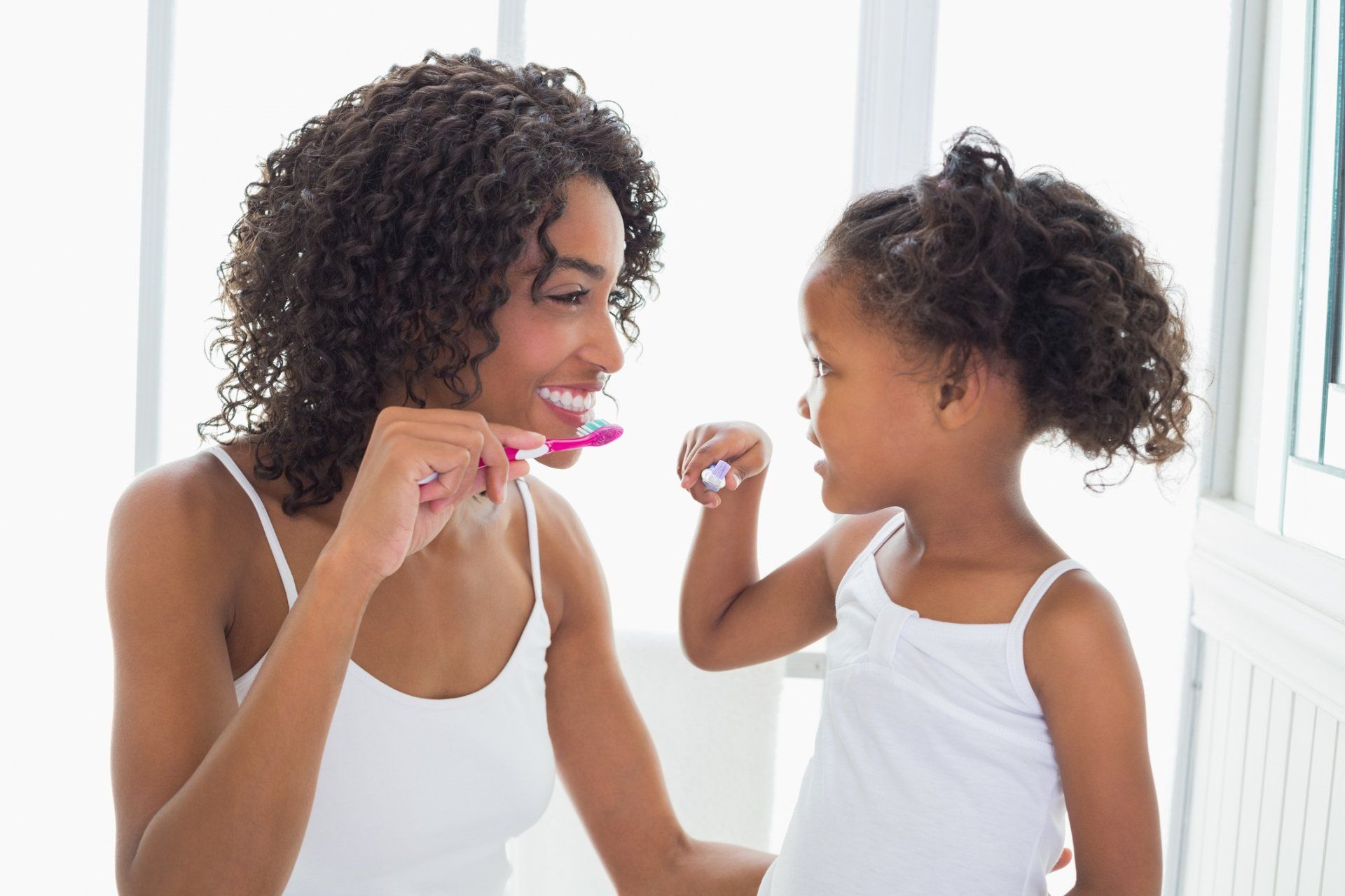 Mother Teaching Daughter How To Brush — Albuquerque, NM — Aragon Pediatric Dentistry