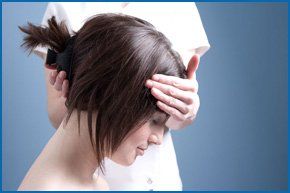 Holistic therapist holding head