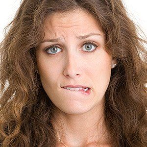 Woman biting her lips — Wyoming, MI — Dental South Woman biting her lips — Wyoming, MI — Dental South