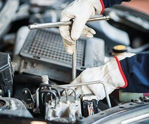 Detail of a Mechanic at Work on Car Engine - Fuel and Emission Parts and Pumps in Bellflower, CA