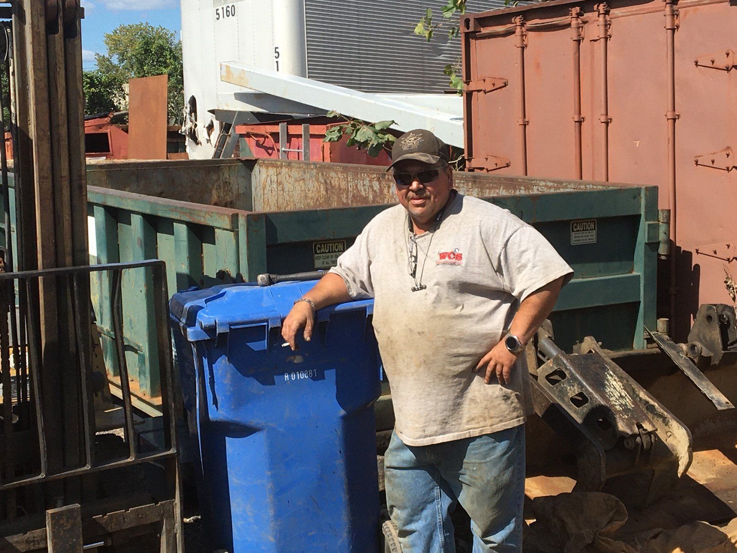 Man Standing Beside A Trash Bin — Richmond, VA — Dominion Salvage Inc