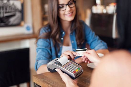 Girl handing over credit card — Family Dental Practice in Fairless Hills, PN Girl handing over credit card — Family Dental Practice in Fairless Hills, PN