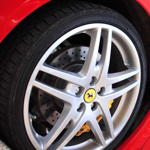 Close up of Ferrari F430 wheel and red bodywork