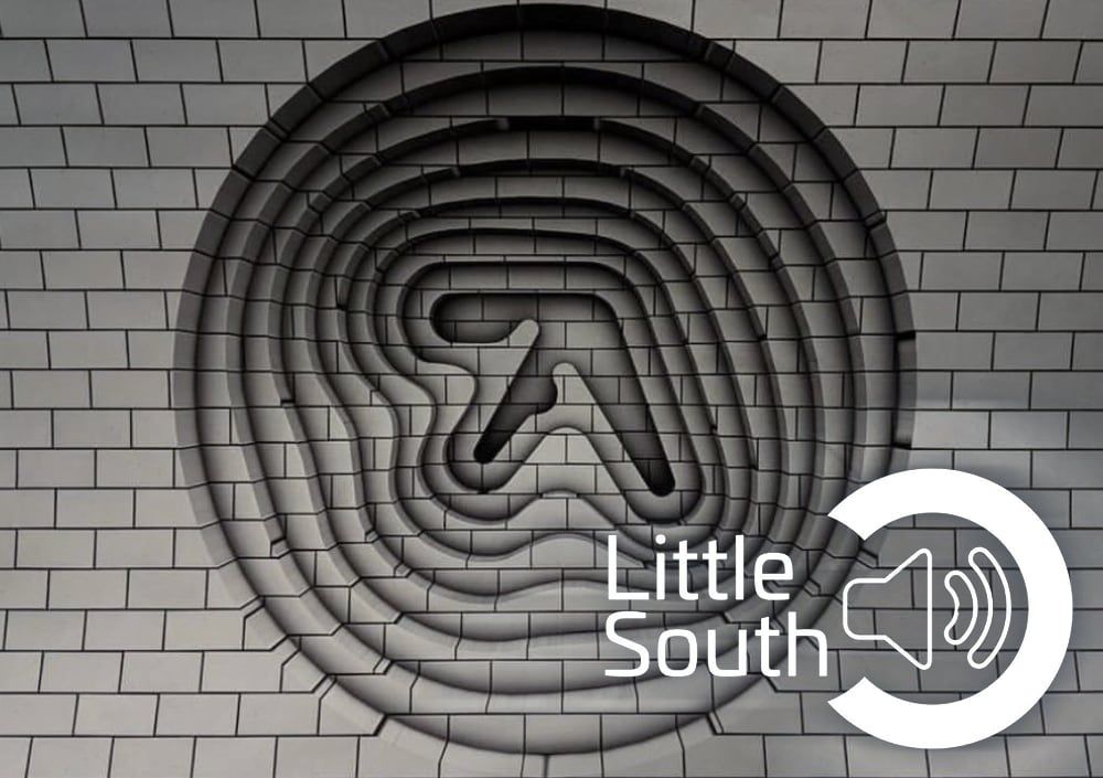 A brick wall with a little south logo on it