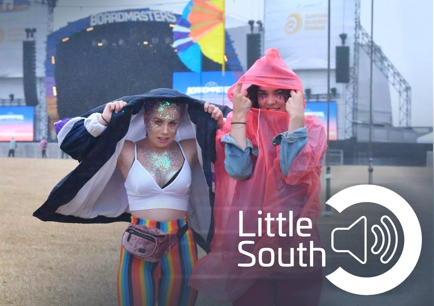 A couple of people standing in front of a little south logo