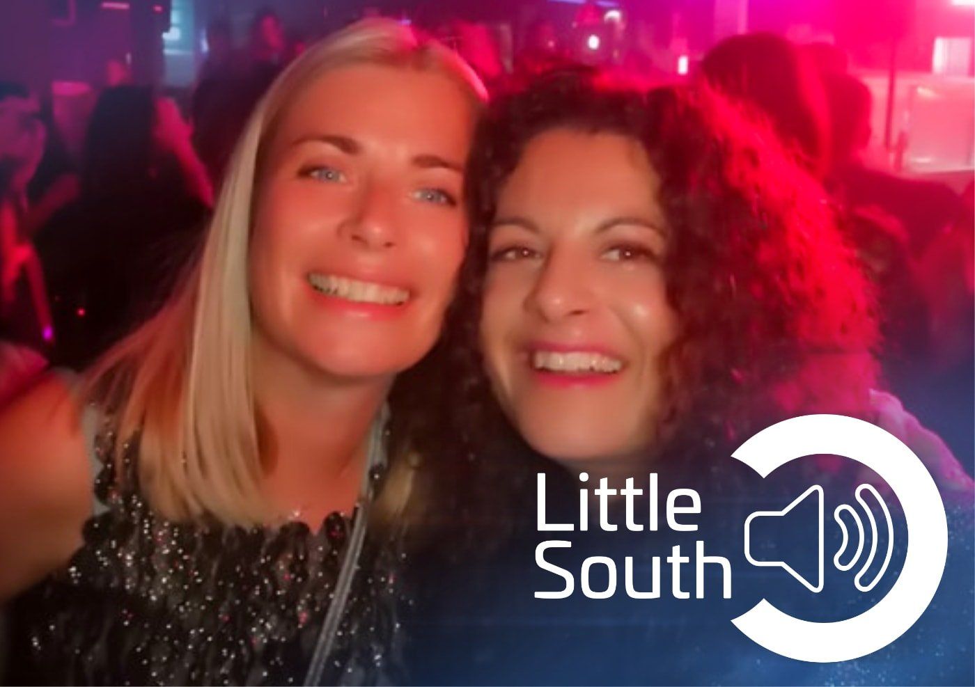 Two women are posing for a picture in front of a little south logo