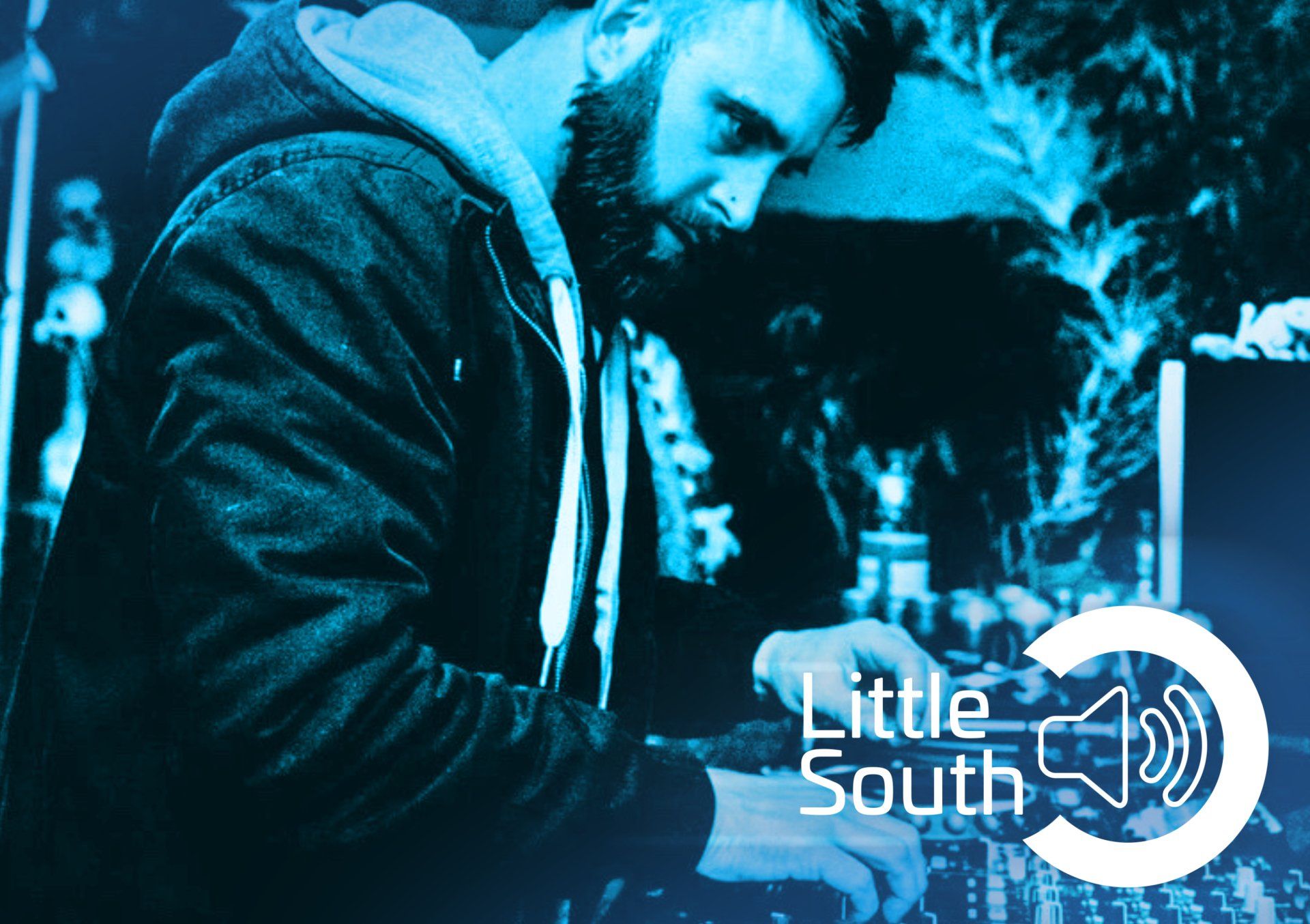 A man with a beard is working on a machine with the words little south on the bottom
