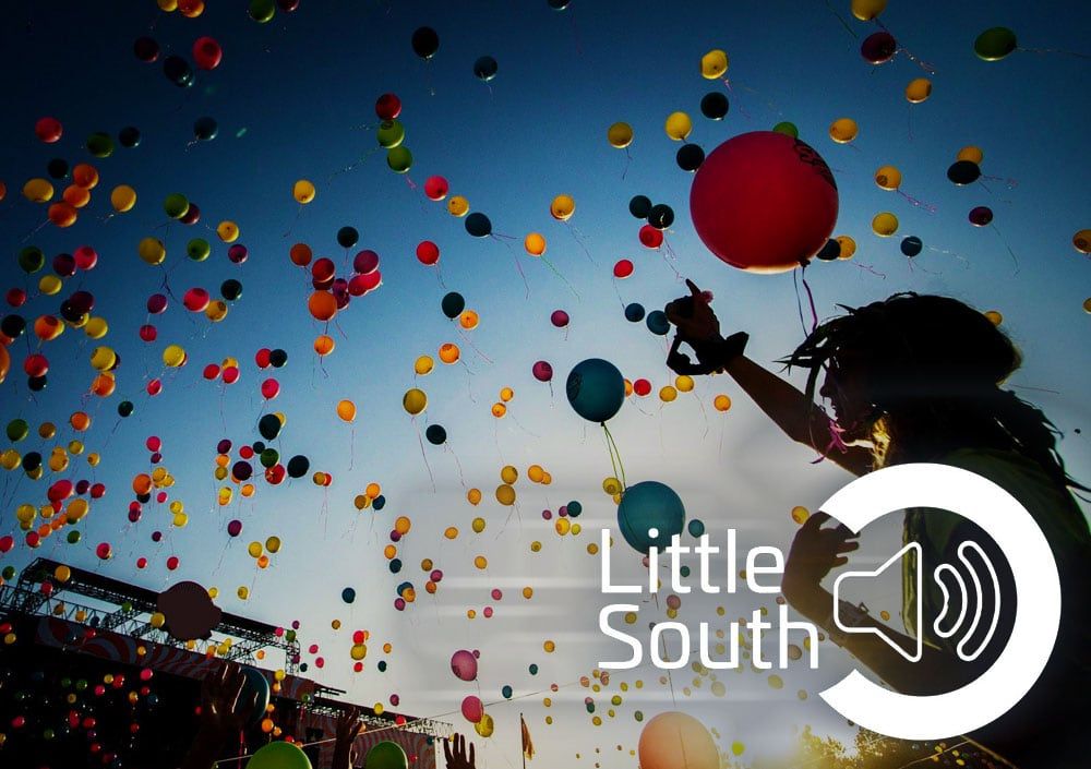 A woman is throwing balloons in the air with the words little south in the corner