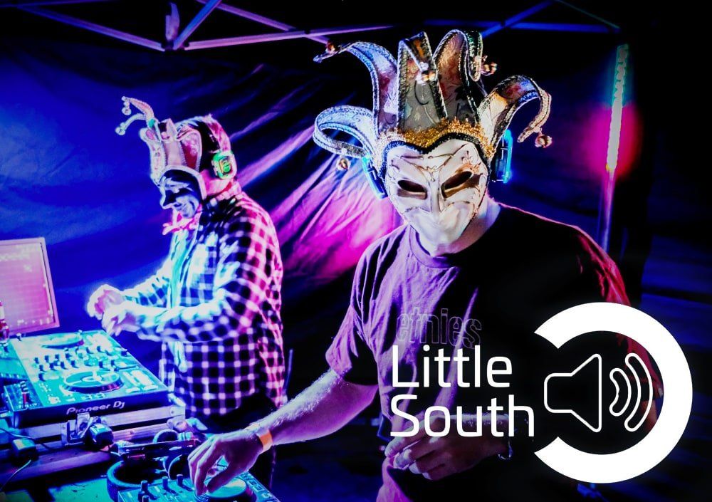 Two men wearing masks are playing music at a little south event.
