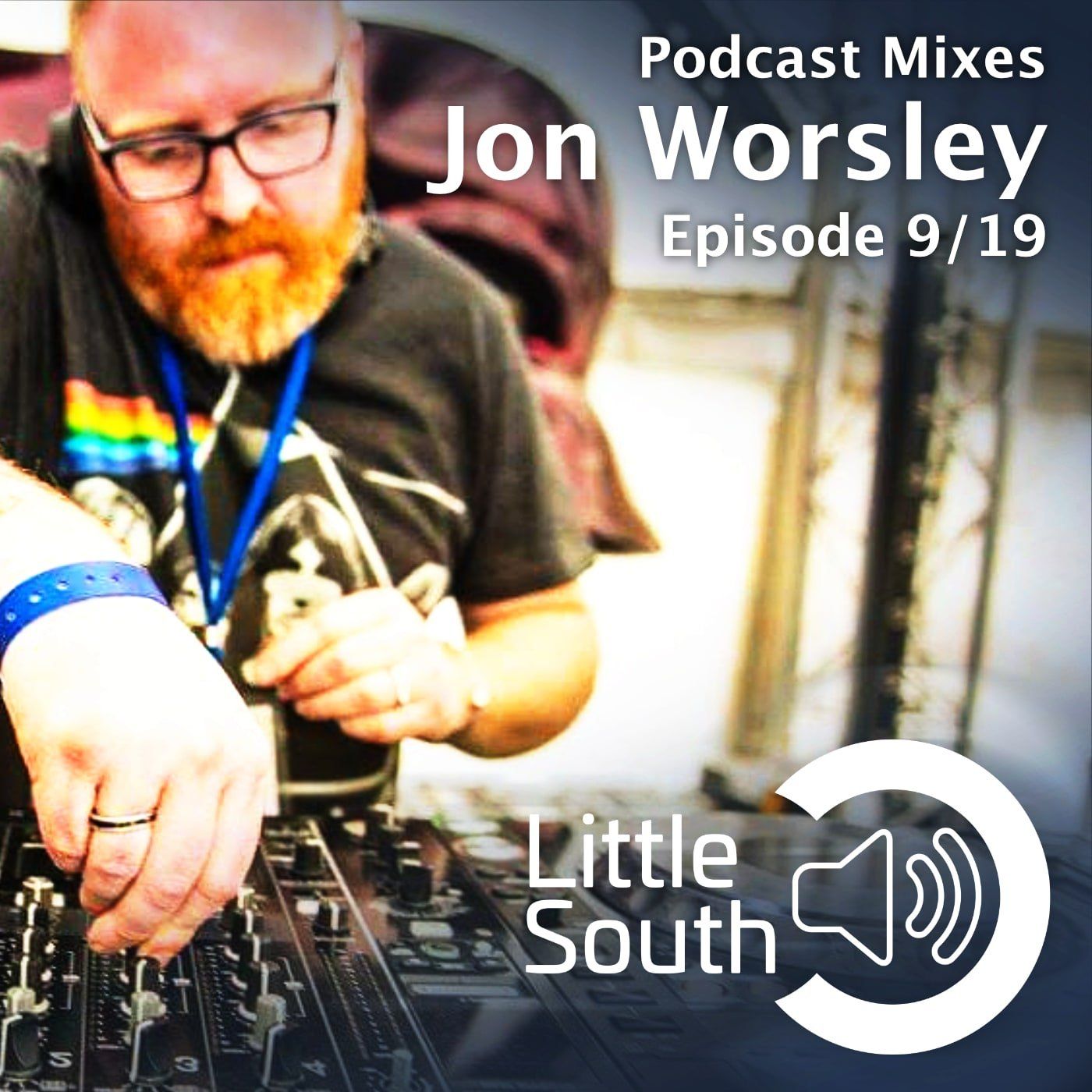 A man with a beard and glasses is playing music on a mixer.