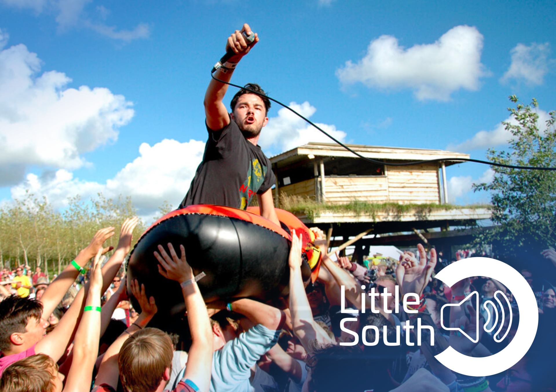 A man is being lifted in the air by a crowd of people.