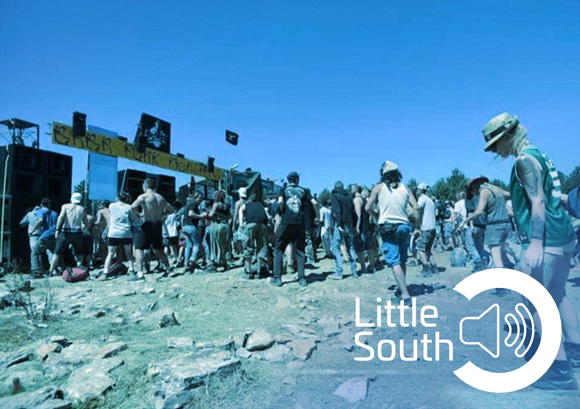 A group of people standing in front of a sign that says little south