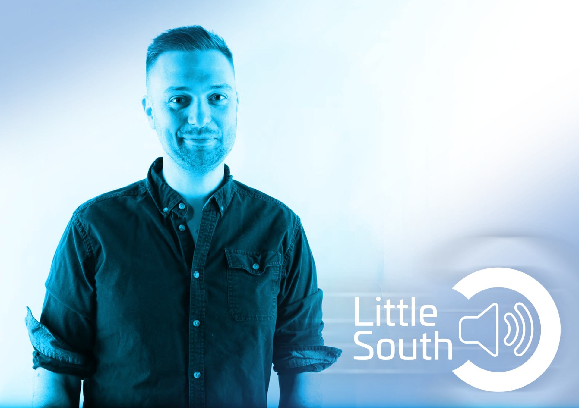 A man in a black shirt is standing in front of a little south logo.