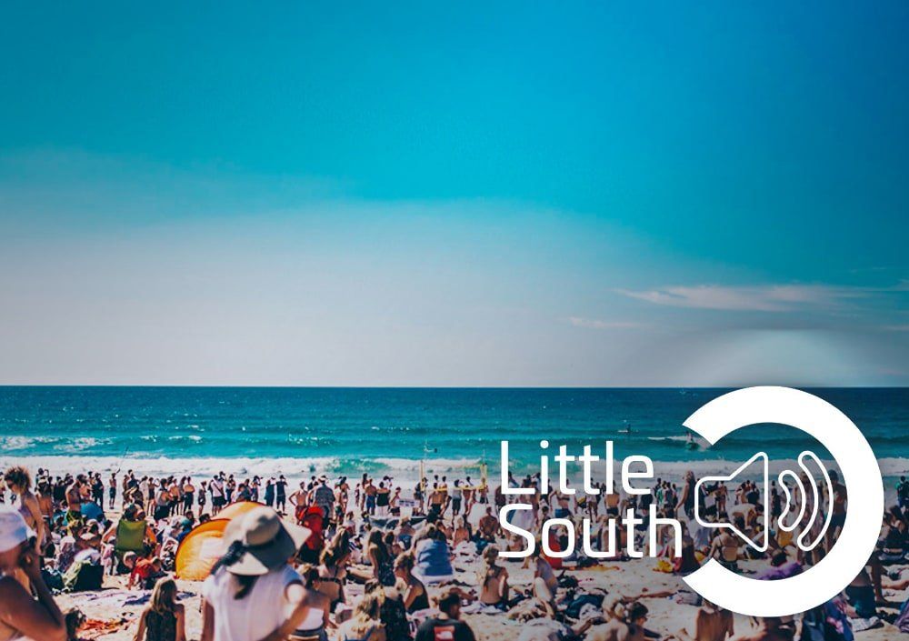 A crowd of people are gathered on a beach with the words little south written on the bottom