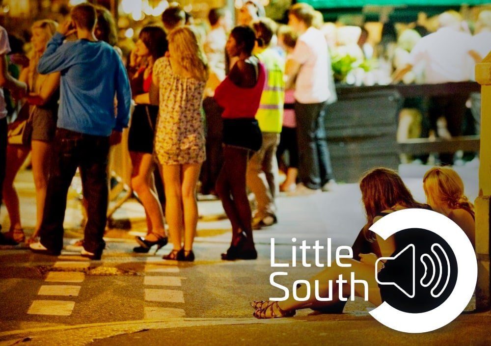 A group of people standing on a street with the words little south on the bottom