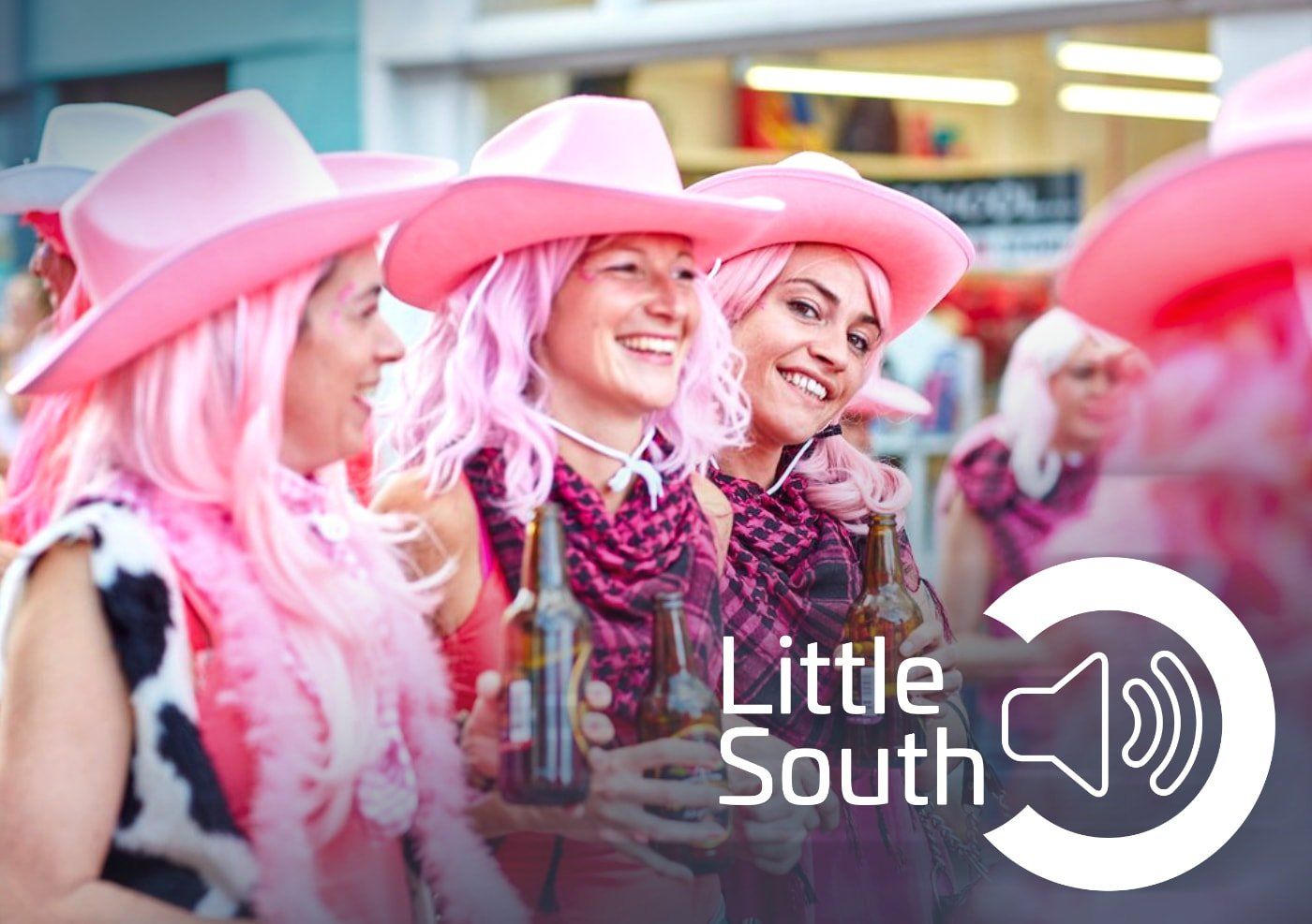 A group of women wearing pink wigs and cowboy hats are holding bottles of beer.