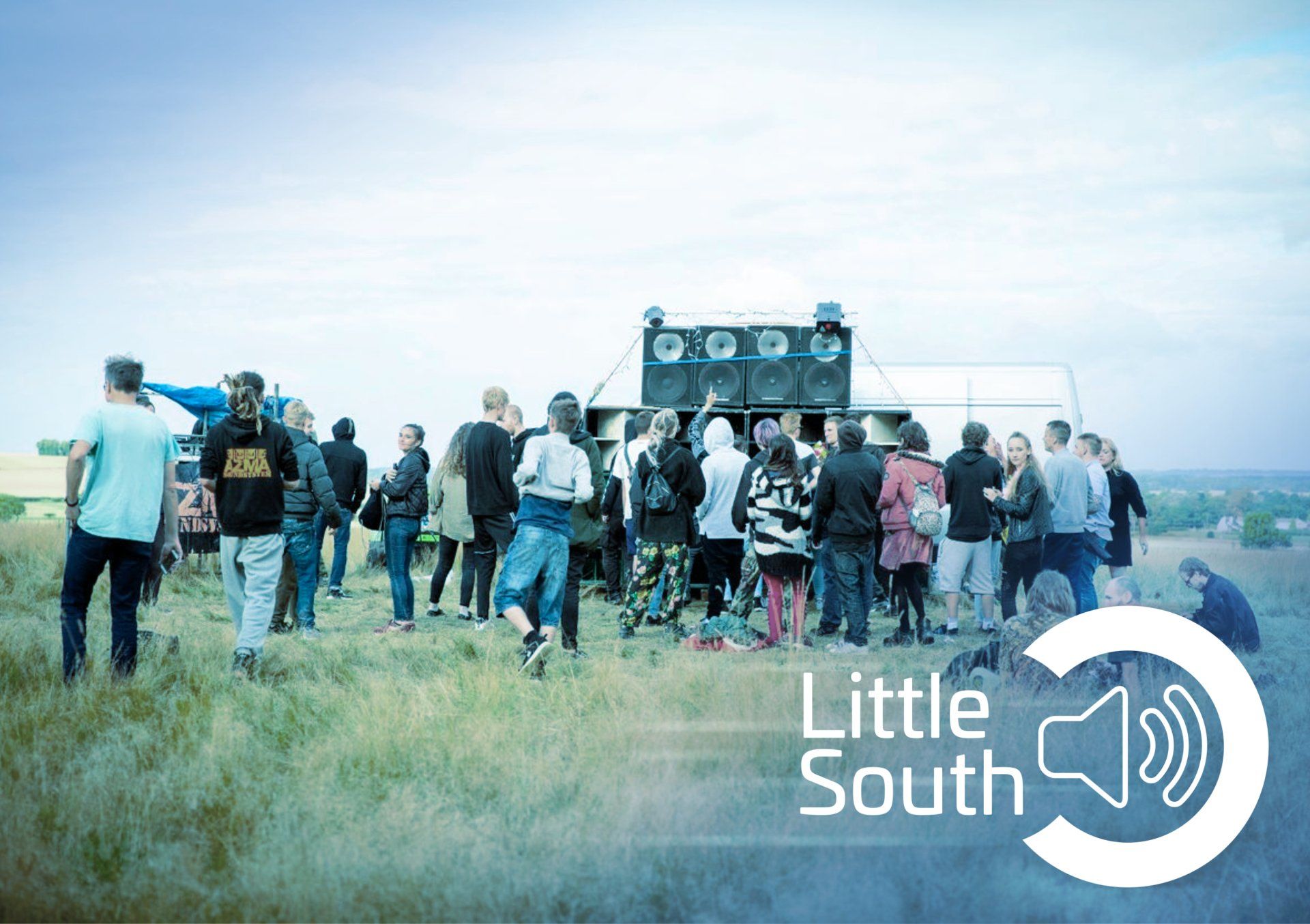 A group of people standing in a field with the words little south on the bottom